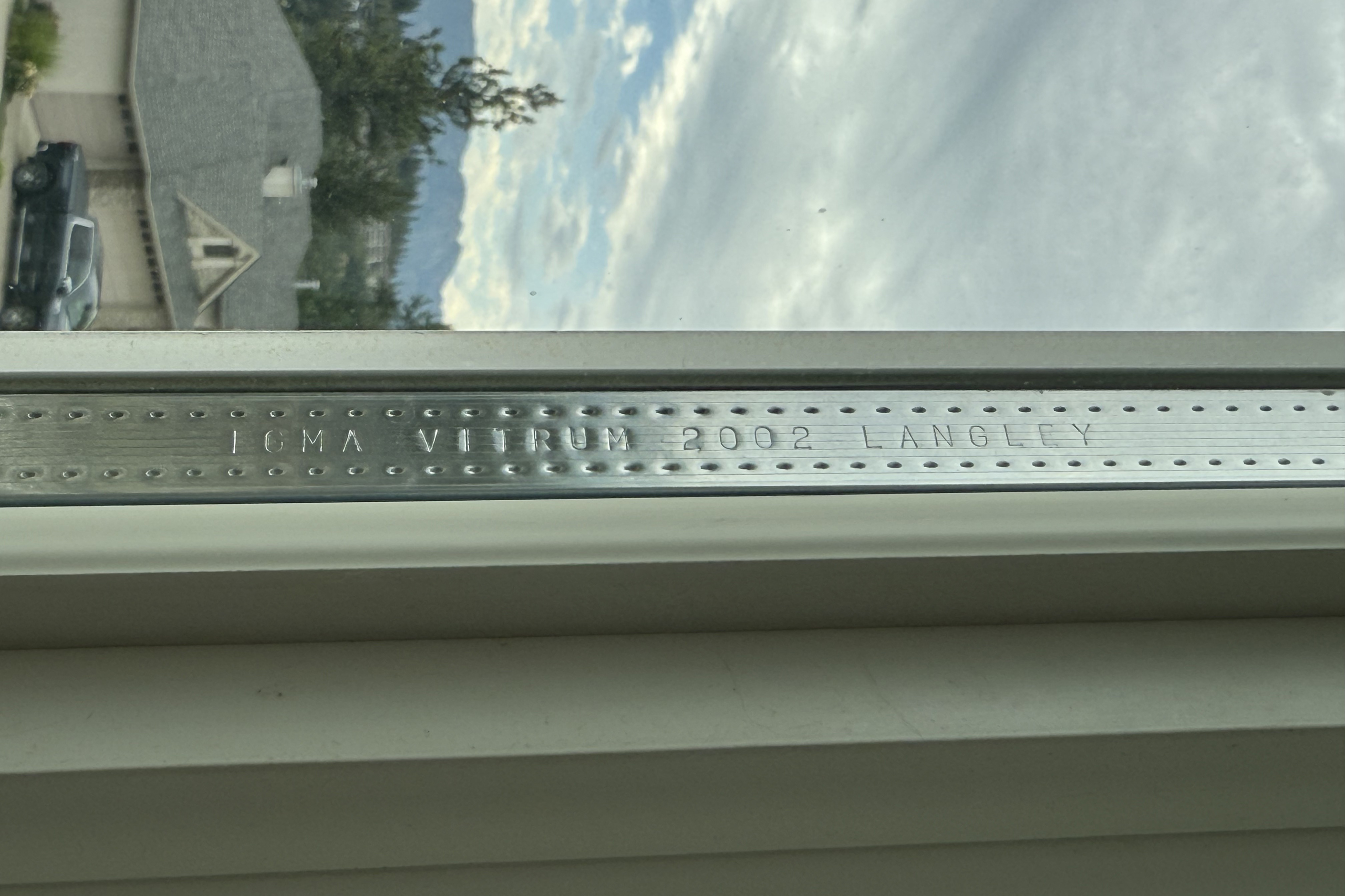 Spacer bar stamped “IGMA VITRUM 2002 LANGLEY,” showing the year of manufacture.