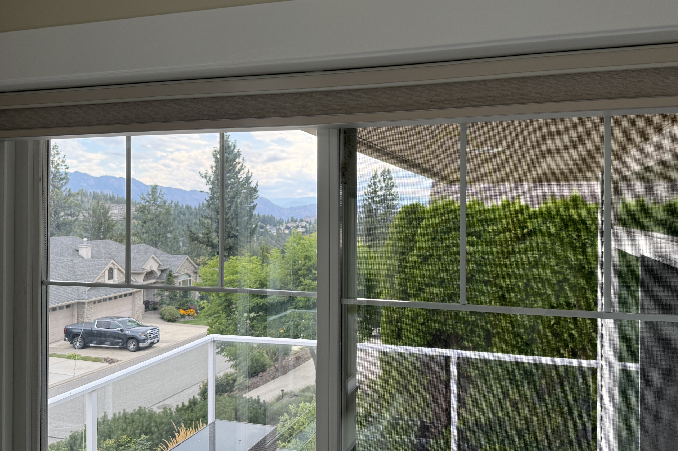 Two adjacent slider windows; the left sash has a replacement IGU and the right is original.