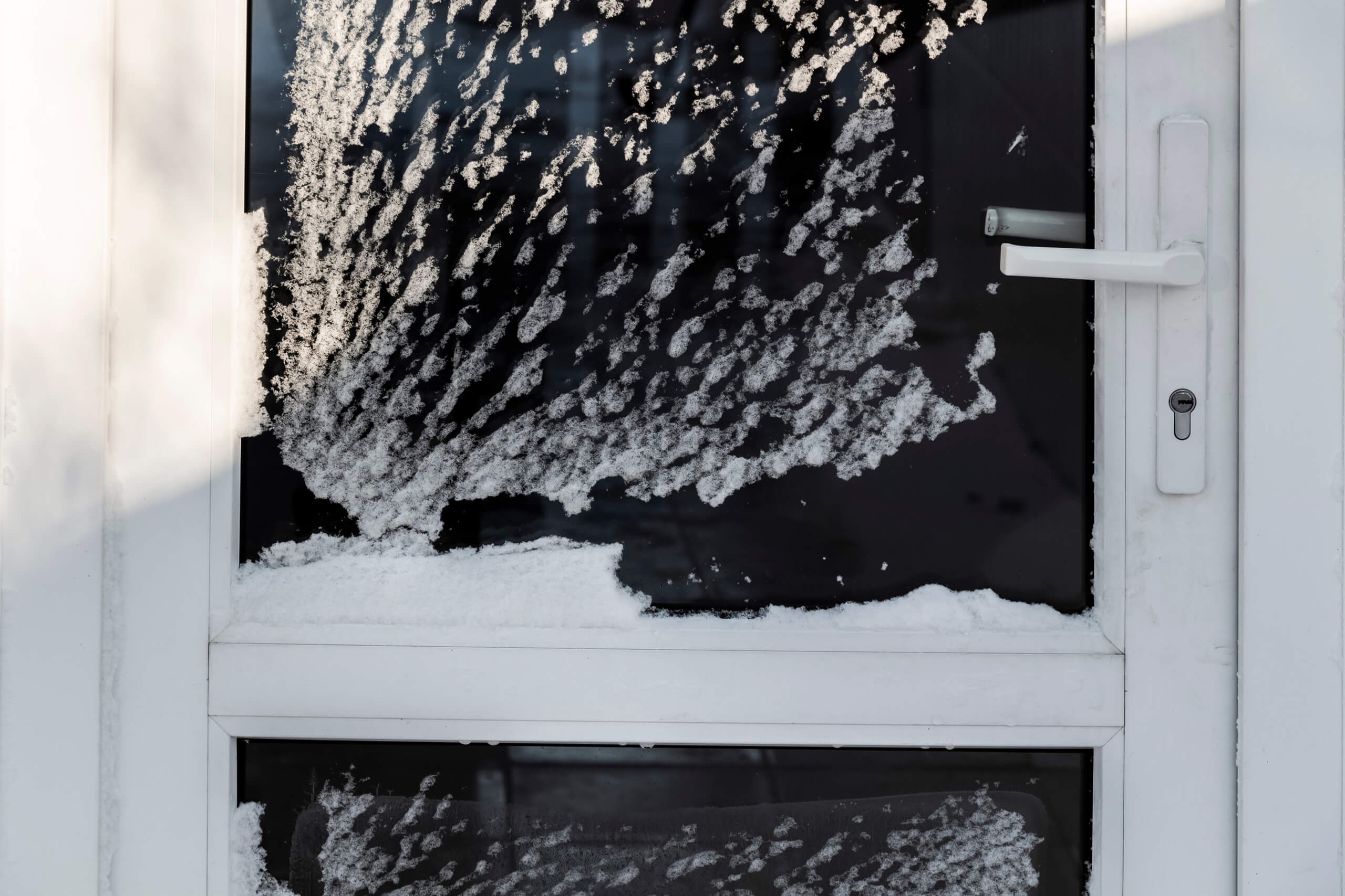 A storm door covered in snow.